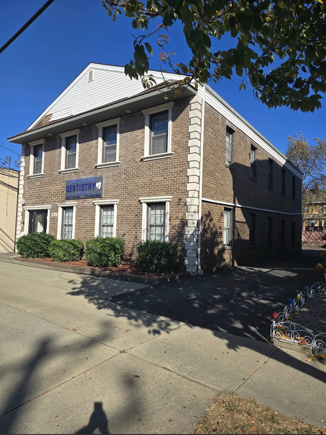 The Lakeview Family Dentistry building, a brick corner building on Lakeview Avenue with the practice sign between the windows and a driveway alongside.