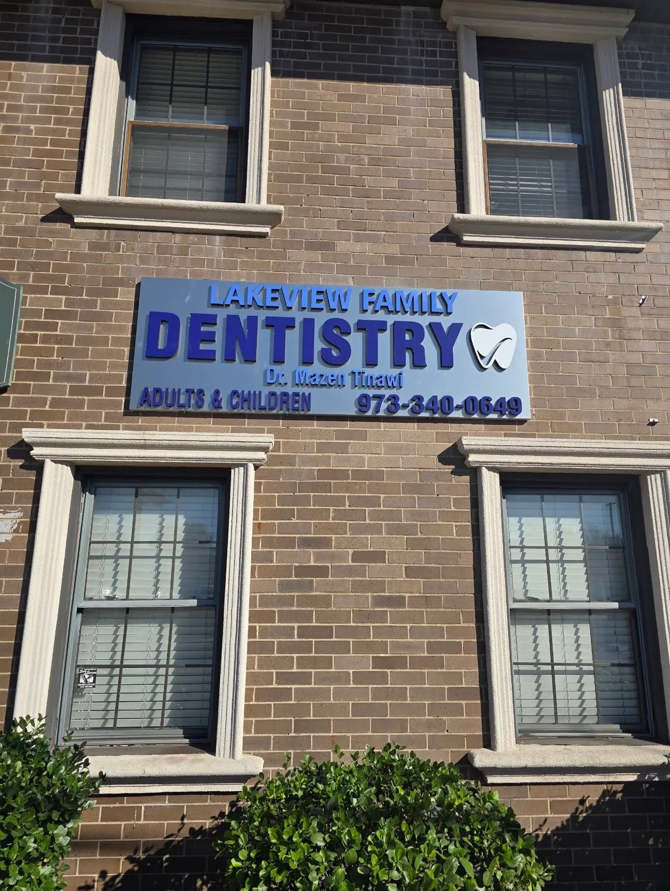 The Lakeview Family Dentistry sign on the brick facade: "Adults & Children, Dr. Mazen Tinawi," with the practice phone number.