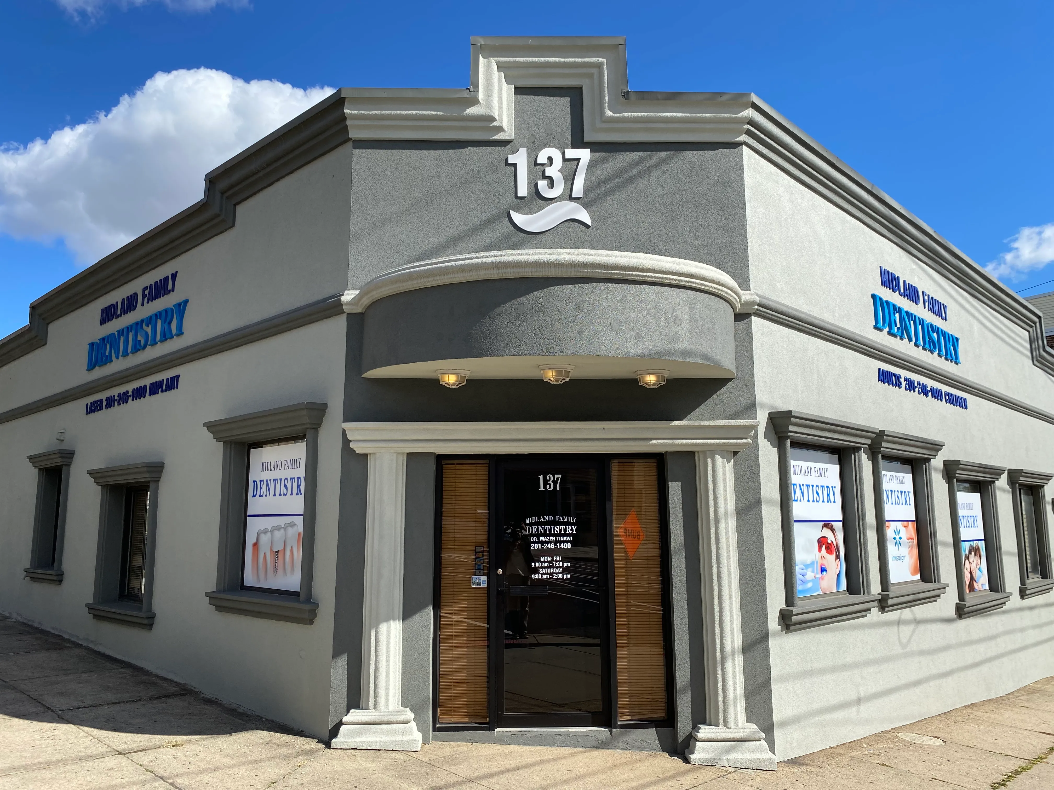 The Midland Family Dentistry building at 137 Midland Avenue: a grey corner building with the practice name on both street-facing walls and a curved awning over the entrance.